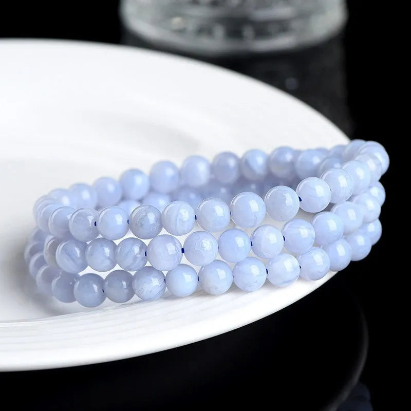Original unisex blue agate beaded bracelet with natural striped patterns and ruyi elements.
