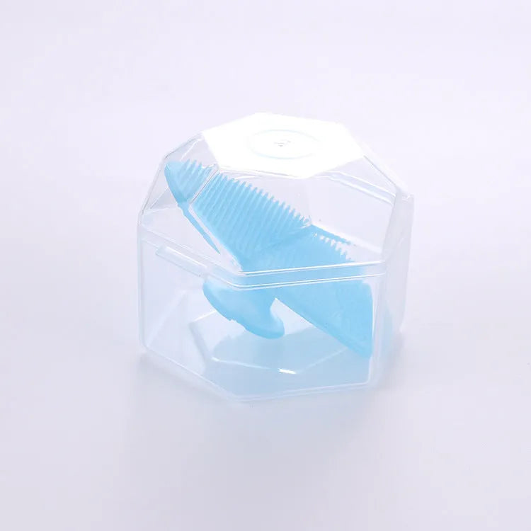 Silicone facial brush in three bristle zones with suction cup on blue background