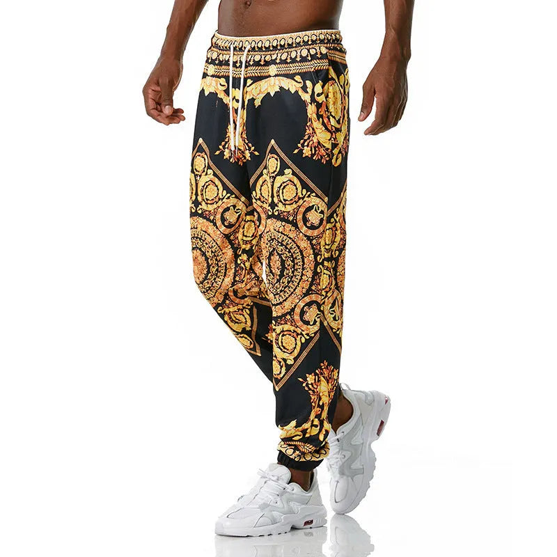 Printed jogging pants in loose fit with digital print pattern, mid waist, drawstring belt, and small-foot ribbed hem