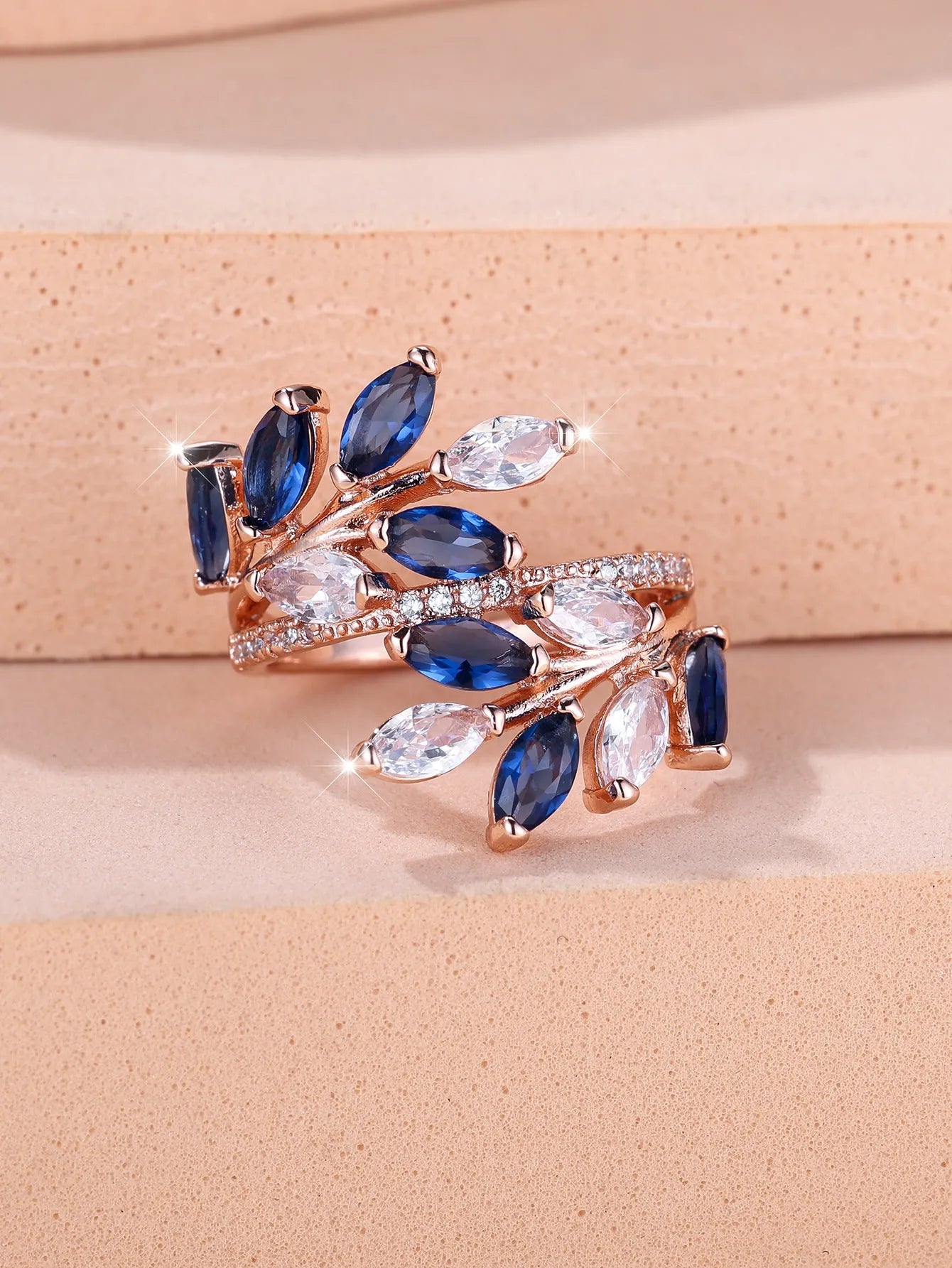 Adjustable copper leaf ring with a zircon stone in a choice of rose gold or platinum finishes.