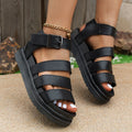 Black outdoor sandals with buckle straps and a thick rubber sole, showing the round toe and fish mouth toe holder design.