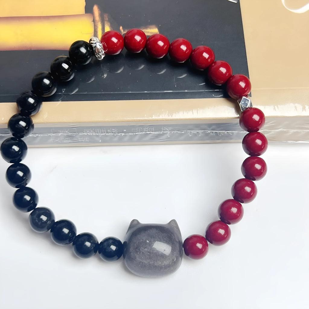 Handmade black obsidian bracelet with cat charm and colourful beads on elastic cord with adjustable ties.