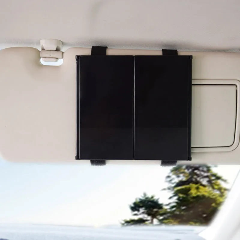 Silver car folding grooming mirror shown opened and closed on a car dashboard.