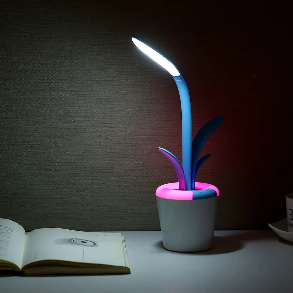 Modern rechargeable LED table lamp in pink with touch control and plant-shaped design on a wooden desk
