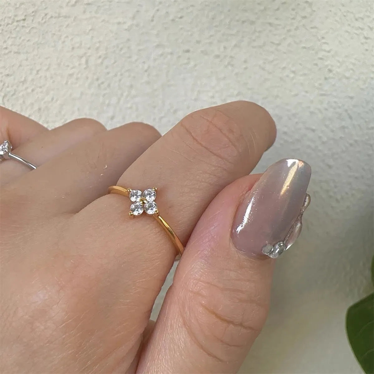 Champagne copper adjustable ring with four-leaf clover and rhinestone flower detail