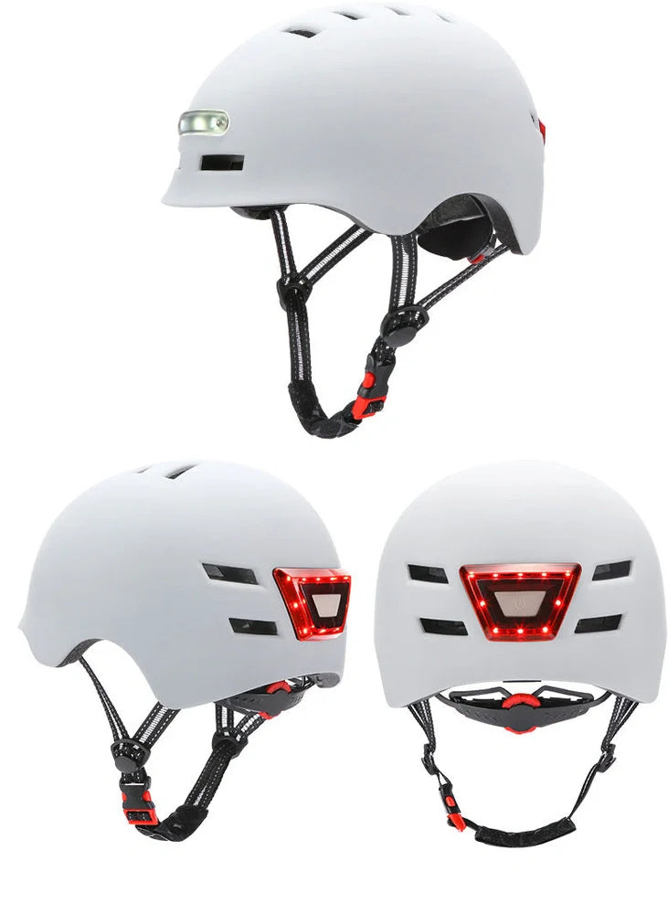 Black cycling helmet with built-in LED headlight and taillight showing adjustable dial and ventilation ports