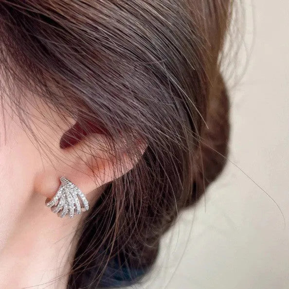 A pair of geometric drop earrings with a platinum electroplated finish on zircon.