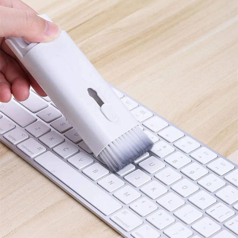 Multifunctional electronics cleaning kit with cleaning pen, brush, key puller, and spray bottle on a white background