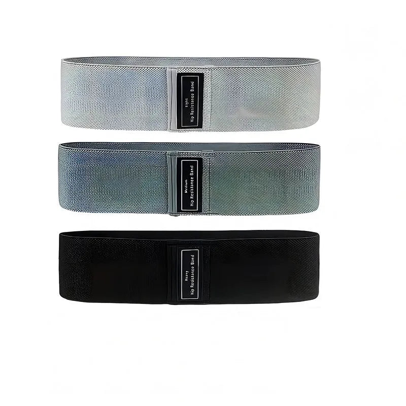 Cloth-covered nylon resistance band in light gray on a gym floor