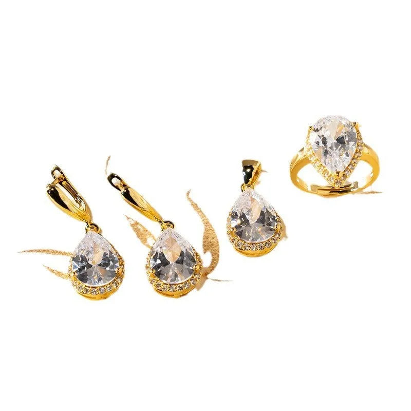 Drop-shaped zircon non-fading three-piece jewellery set gold plated with mixed gem inlaid pendant in emerald gold colour on white background