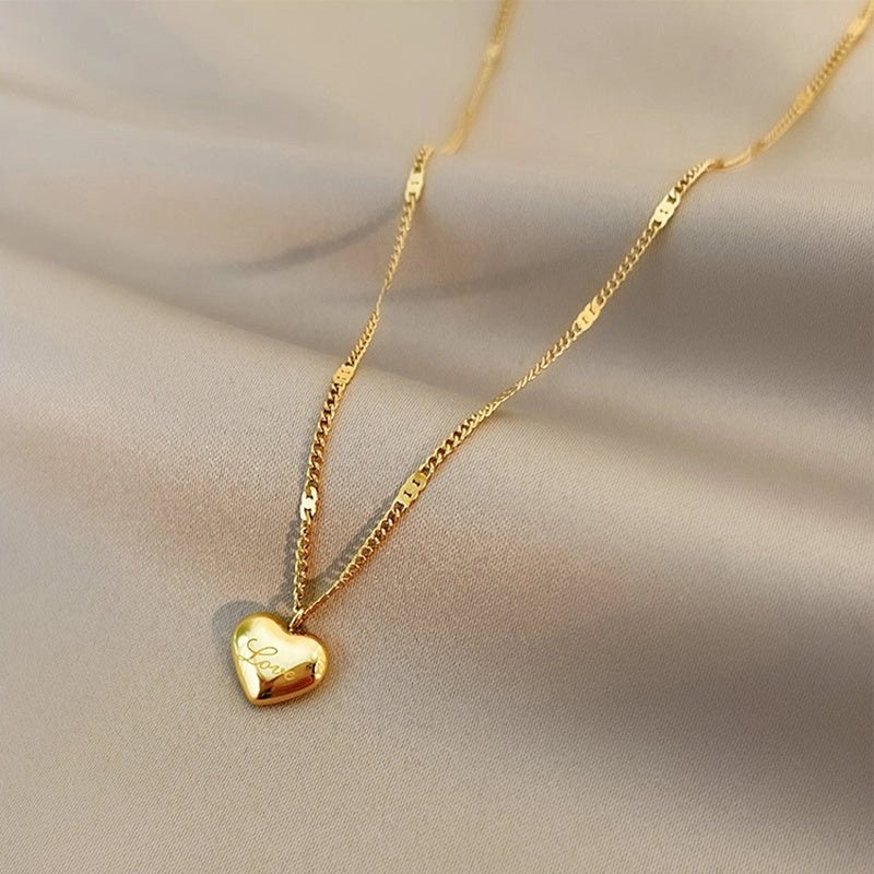 Vintage gold-toned love heart pendant necklace on a sectional chain