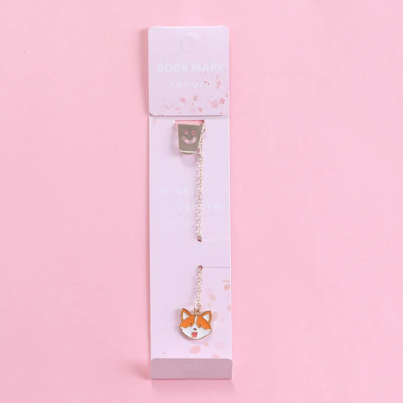 Colourful metal bookmark with a small cartoon pendant charm, showing panda and rocket design options.