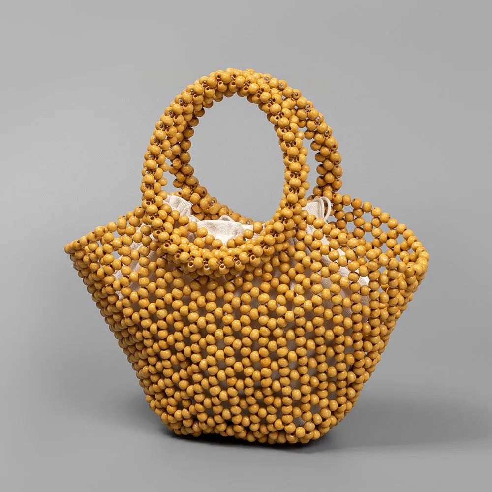 Maple wood woven dumpling-shaped handbag with wooden bead decoration, shown in milky white.