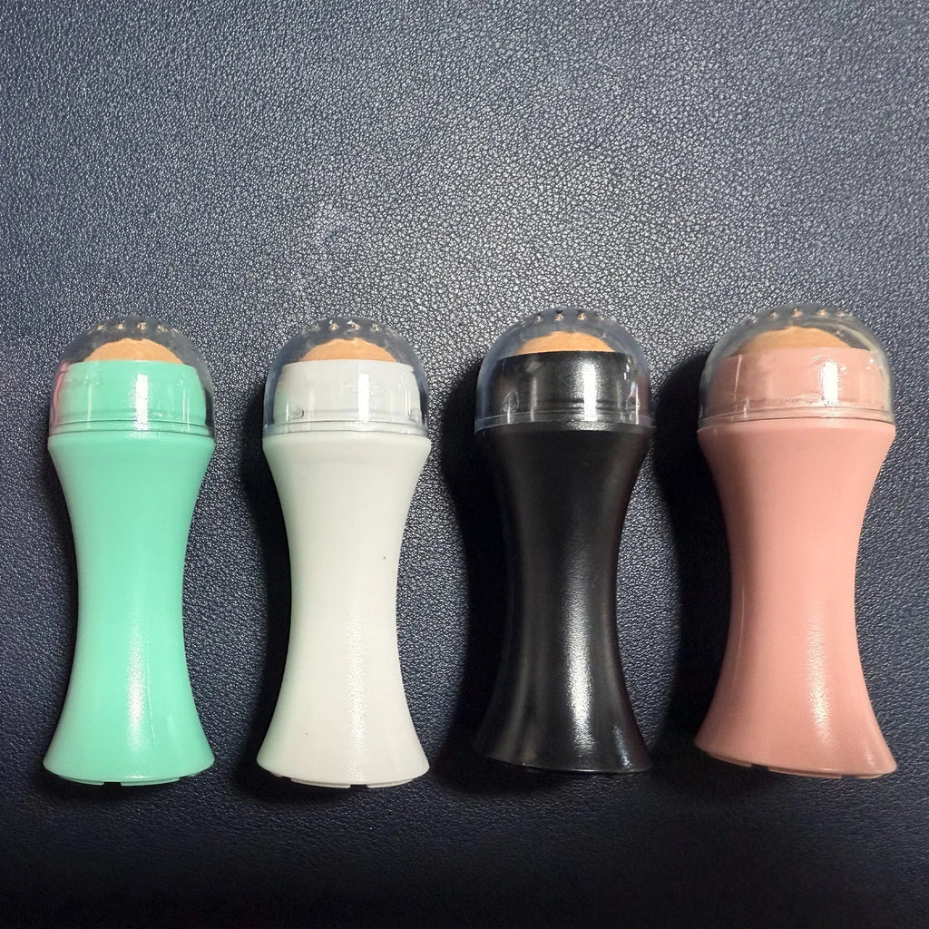 Portable black volcanic stone facial roller for oily skin control and makeup touch-ups.