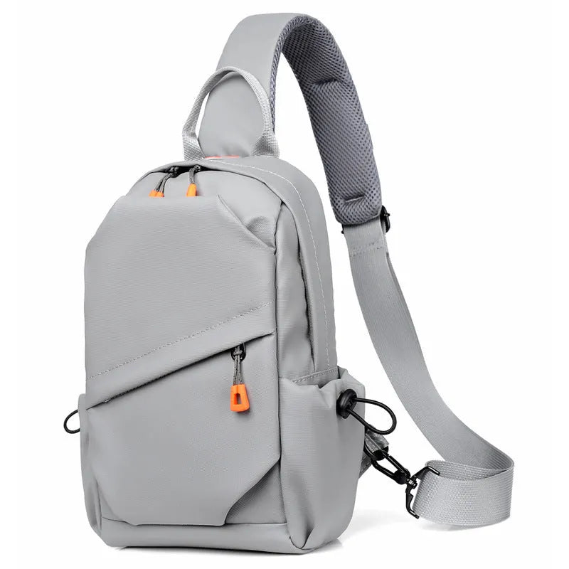 Men's black polyester crossbody bag with a single shoulder strap, shown in a casual setting.