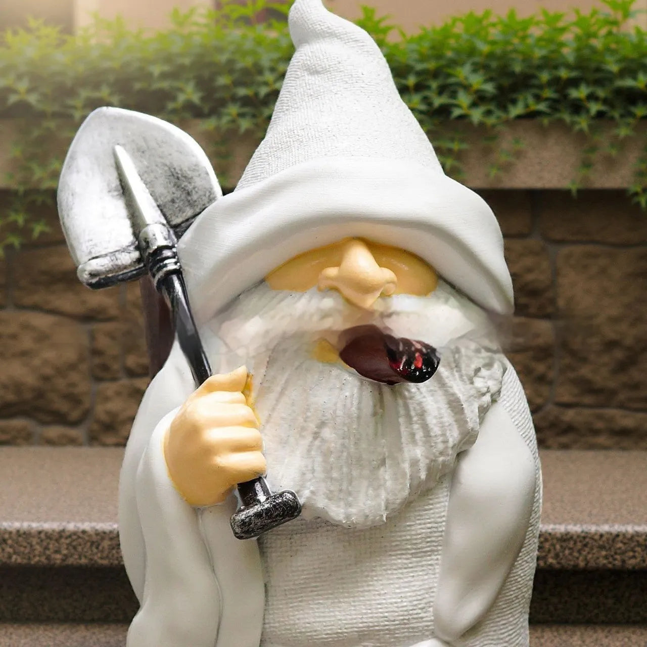 Resin Christmas ornament depicting dwarf character holding smoking pipe and shovel