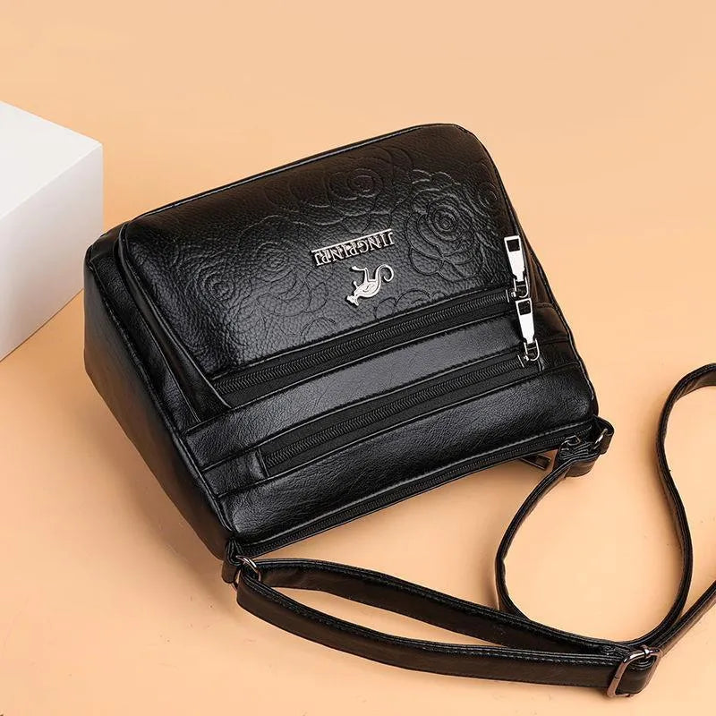 Women's black PU leather messenger bag with embossing and sewing thread details, horizontal square shape, single shoulder strap