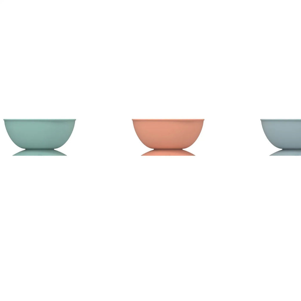 Cyan silicone dog bowl with textured slow-feeding surface and suction cup base.