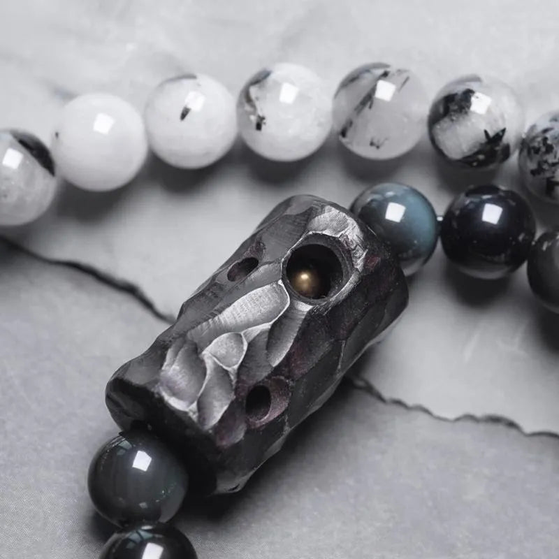 Ethnic style black hair bracelet with white crystal tassel showing bending and lacing construction details