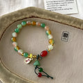 Handmade mixed material bracelet featuring a Lotus and Ruyi charm design, M990 style.
