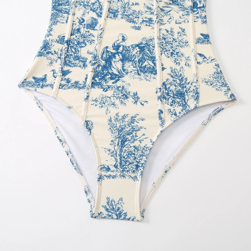 Blue women's one-piece polyester swimsuit with matching gauze skirt laid flat