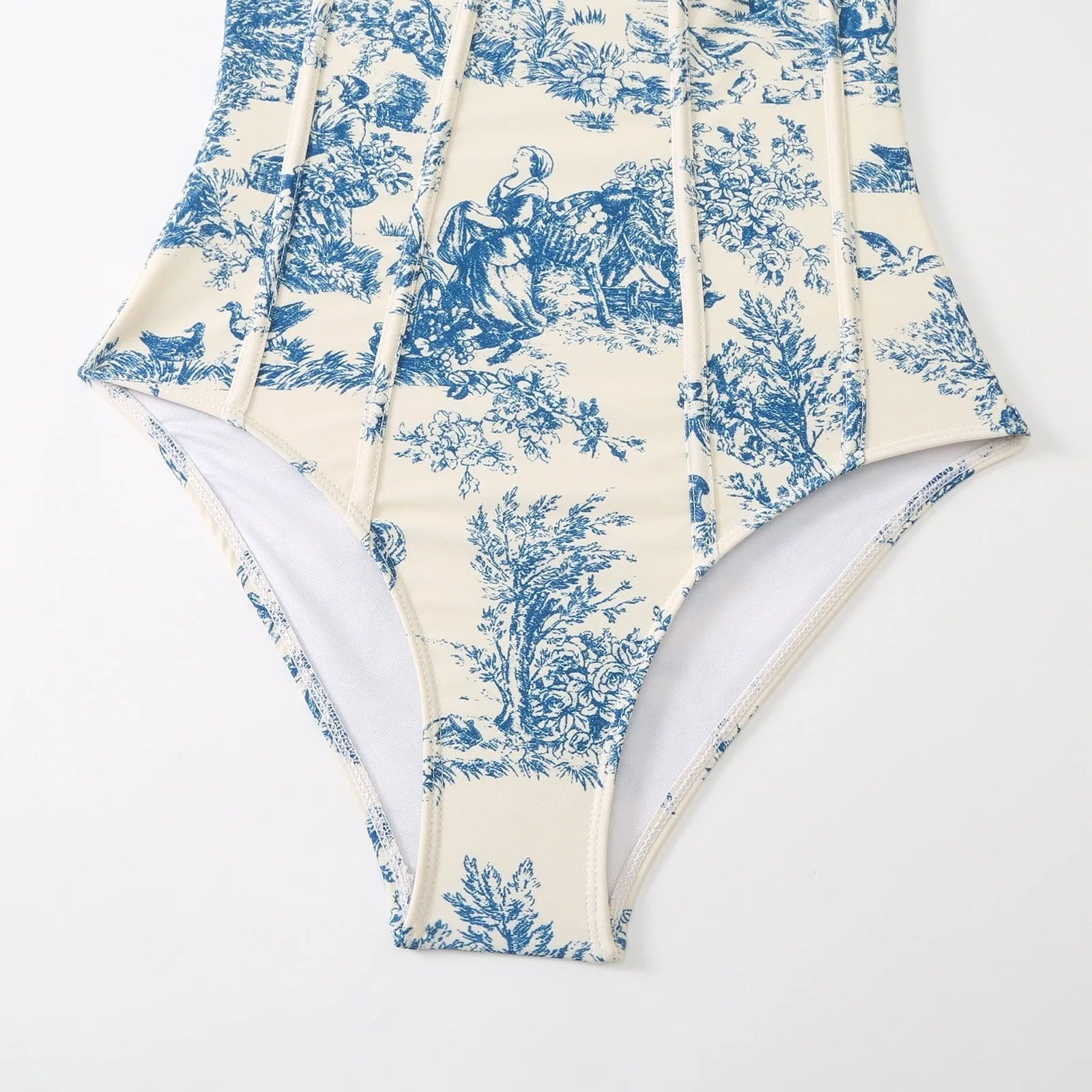 Blue women's one-piece polyester swimsuit with matching gauze skirt laid flat