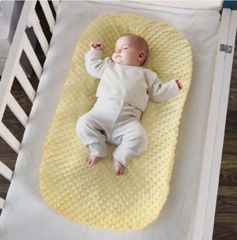Newborn bionic nap bed in blue and yellow, featuring anti-pressure design and washable fabric