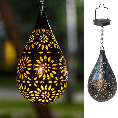 Solar-powered outdoor hanging lantern with flower-shaped light patterns and waterproof design for garden and patio decor