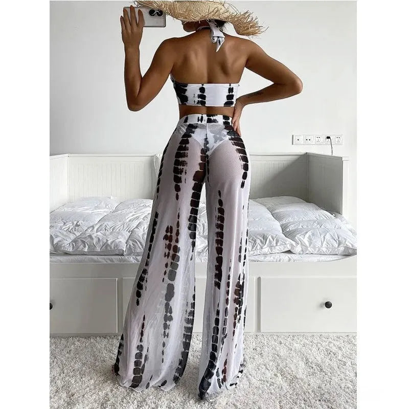 Women's three-piece swimsuit set with bikini top, bottom, and separate mesh trousers in a printed pattern.