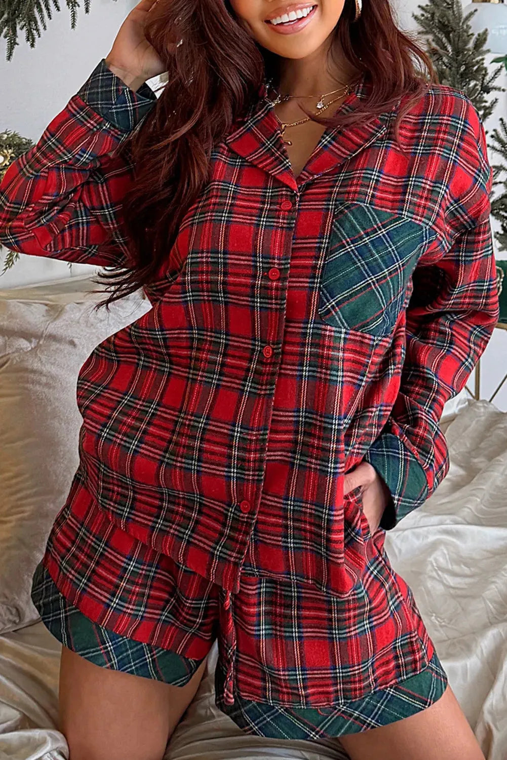 Red plaid Christmas pyjama set for adults, featuring a long sleeve shirt and shorts with contrast patches.