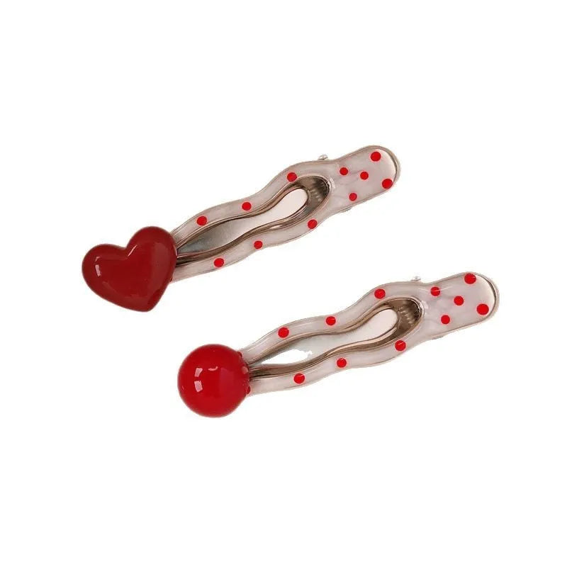 Red stereo love heart-shaped hair clip with French retro dots and willow leaf design.