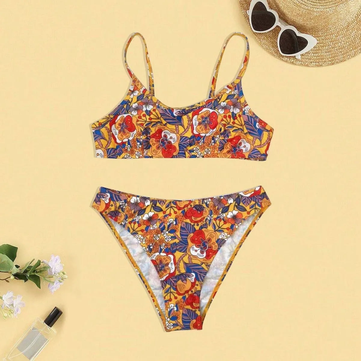 Plus size women's floral print bikini swimsuit with strap design on white background