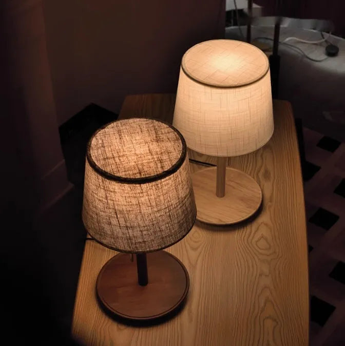 Walnut-coloured solid wood desk lamp with a white fabric lampshade and a black cord switch