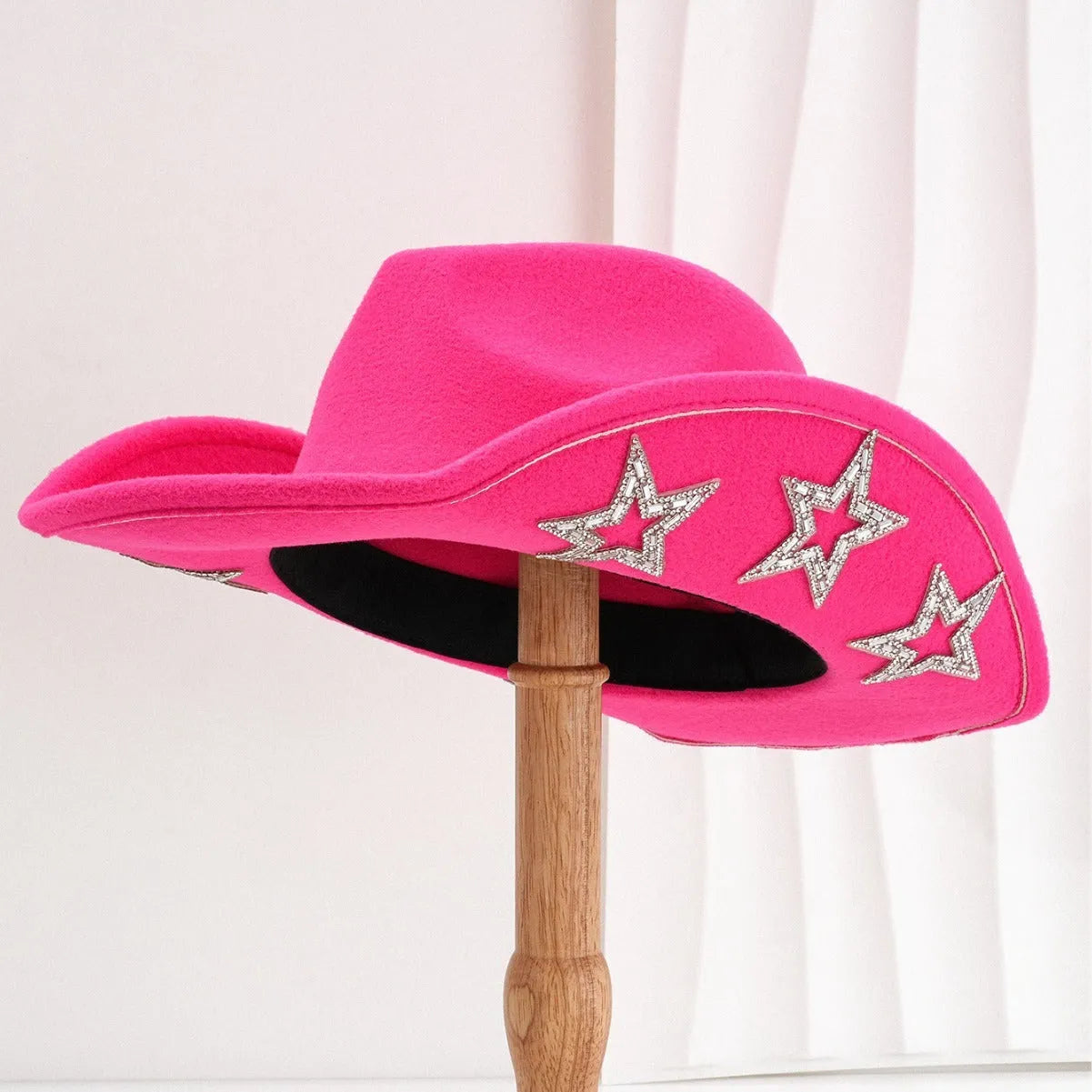 Beige woolen felt Western-style top hat with a conical crown and a silver hexagonal star decoration on the front.