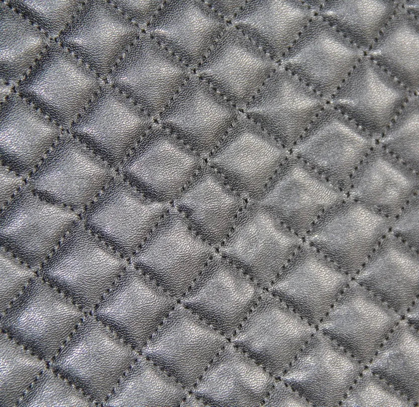 Black quilted car seat cover made of PU and polyester fabric with sponge padding.