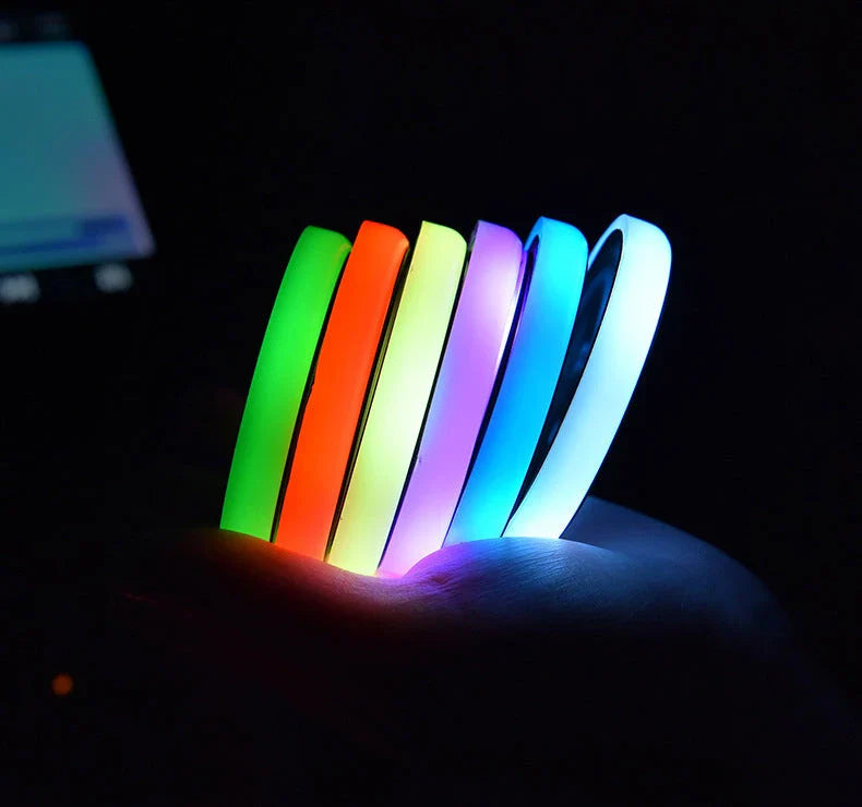 Colorful car cup holder with LED lights that can be charged via USB or solar power, providing a customizable ambient glow for your vehicle's interior