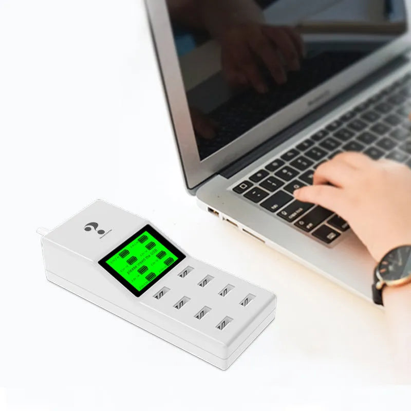 White multi-port USB mobile phone charger with UK, EU, US plug adapters on a desk