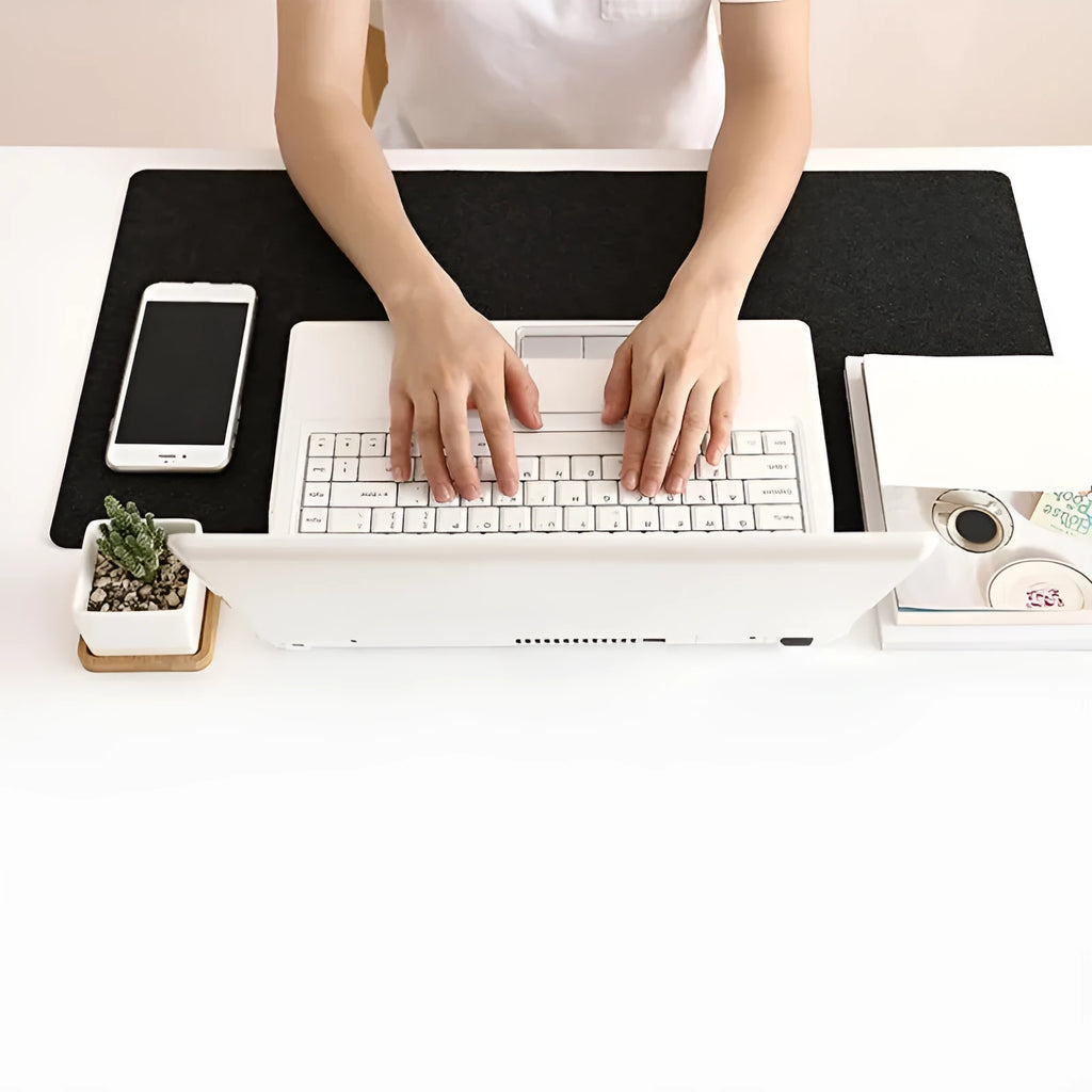 Large felt mouse pad in black on office desk with keyboard and mouse, 325x635mm