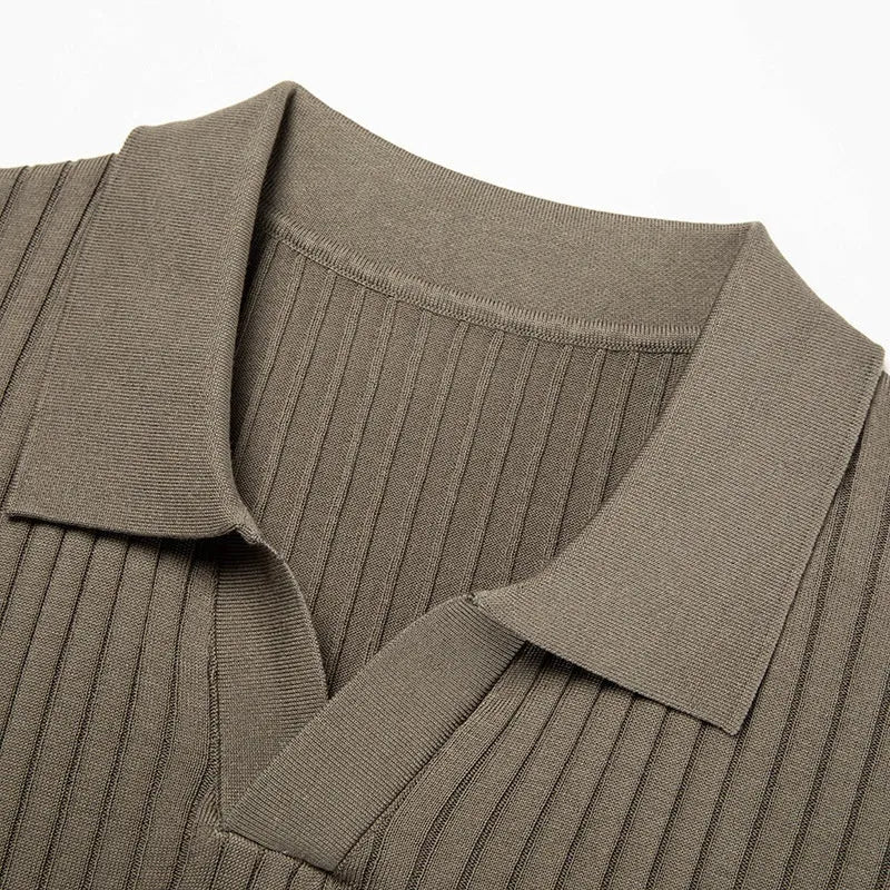 Man wearing a striped mulberry silk lapel T-shirt in grey, showing short sleeves and a straight fit.
