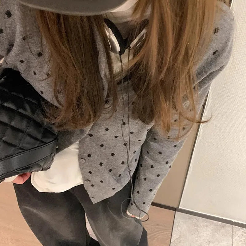 Women's loose grey knitted cardigan with crocheted dot flowers, long sleeves.