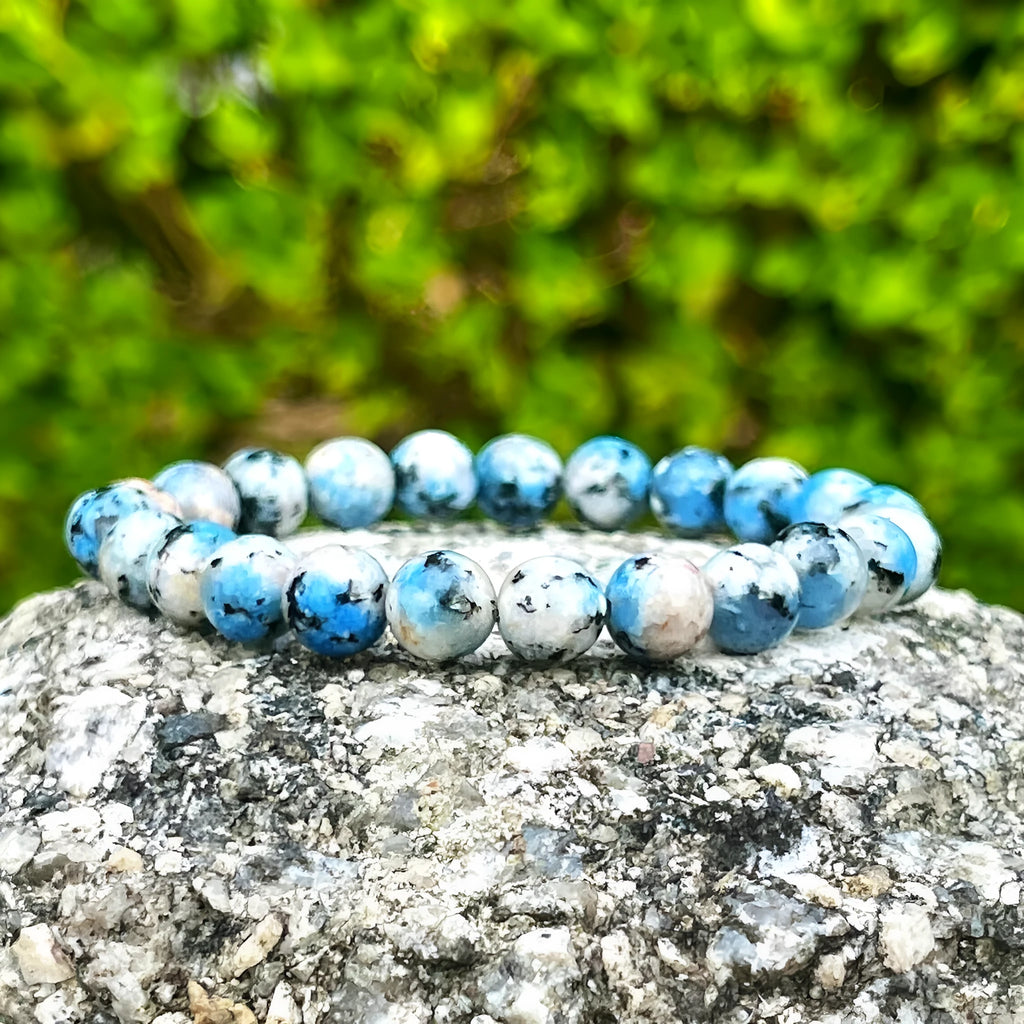Handmade blue-green K2 Azurite stone bracelet with geometric beads on a wrist.