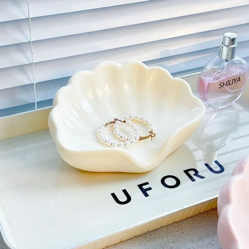 Shell-shaped plastic soap dish in pearl white or cherry blossom pink for bathroom use