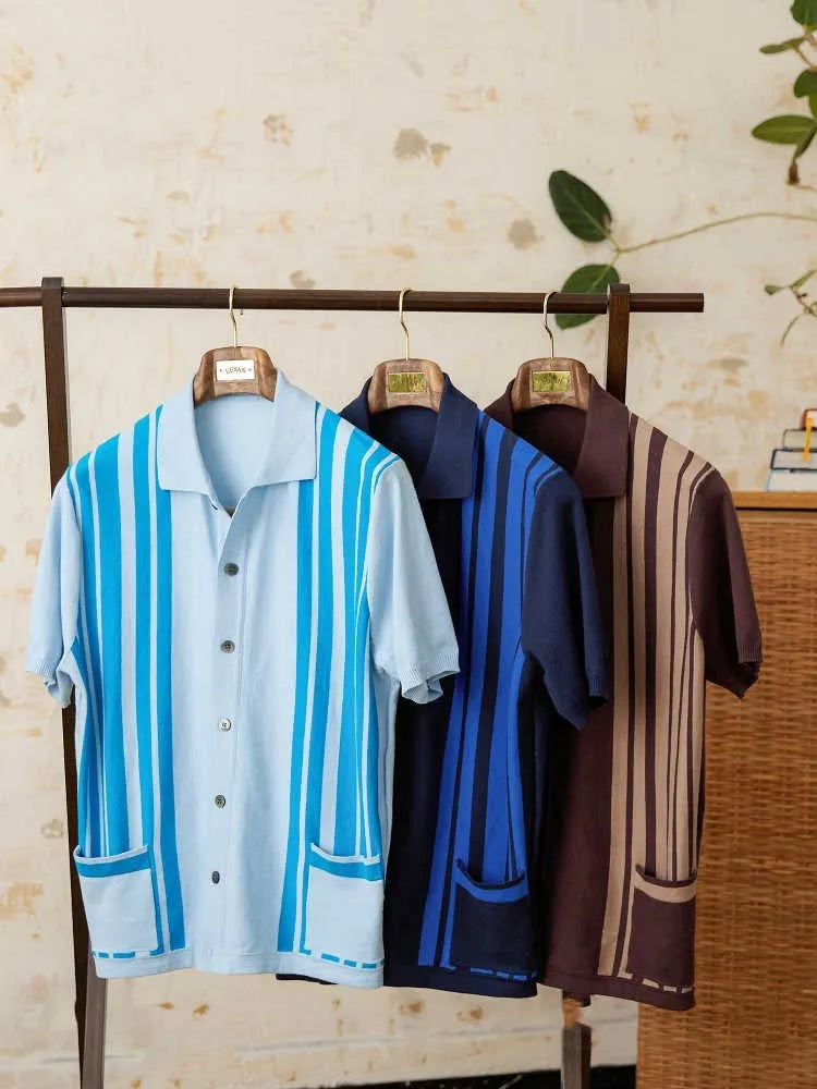 A striped royal blue short-sleeved polo cardigan shirt with a lapel collar, laid flat.