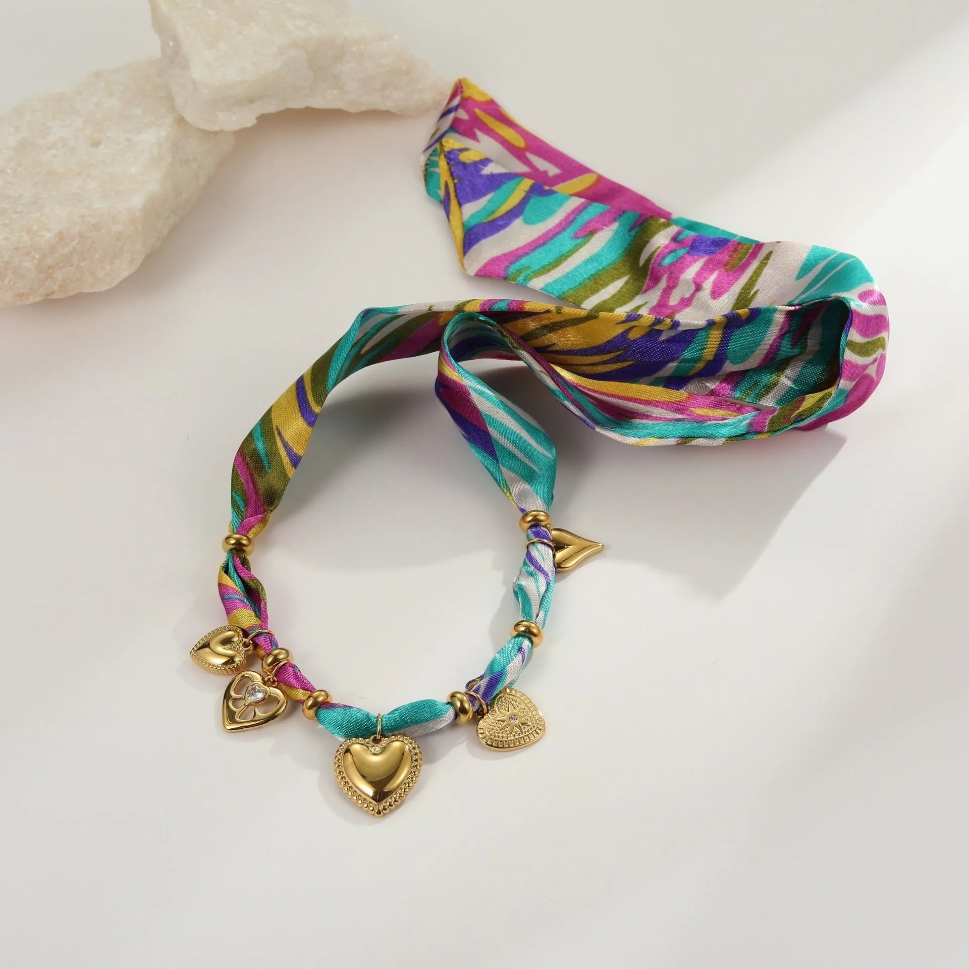 Geometric pendant jewellery with adjustable chain on stainless steel background