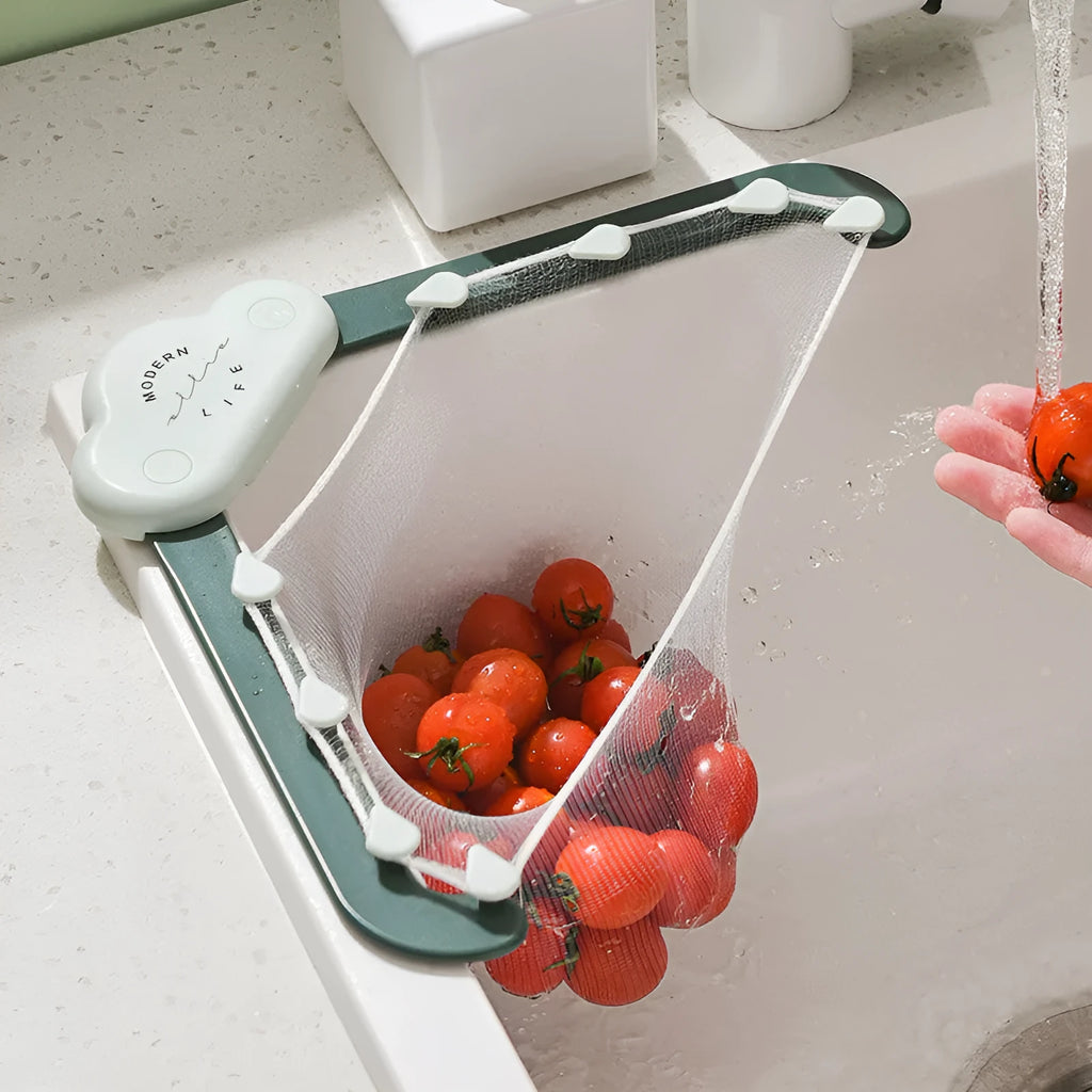 Green triangular sink drain rack with mesh filter bag installed in a kitchen sink corner