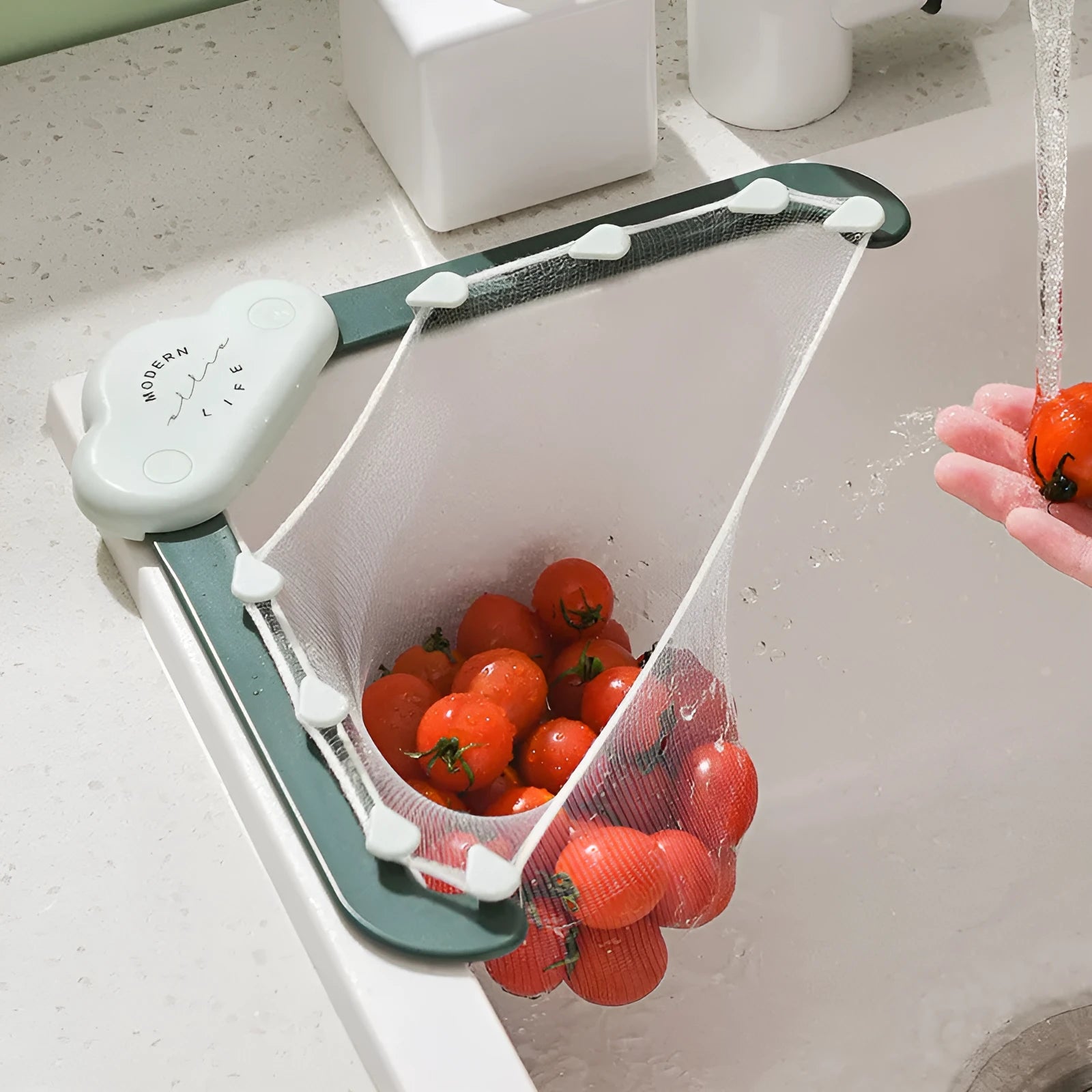 Green triangular sink drain rack with mesh filter bag installed in a kitchen sink corner
