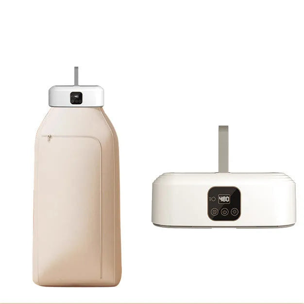 White cylindrical foldable clothes drier with remote control on a table.