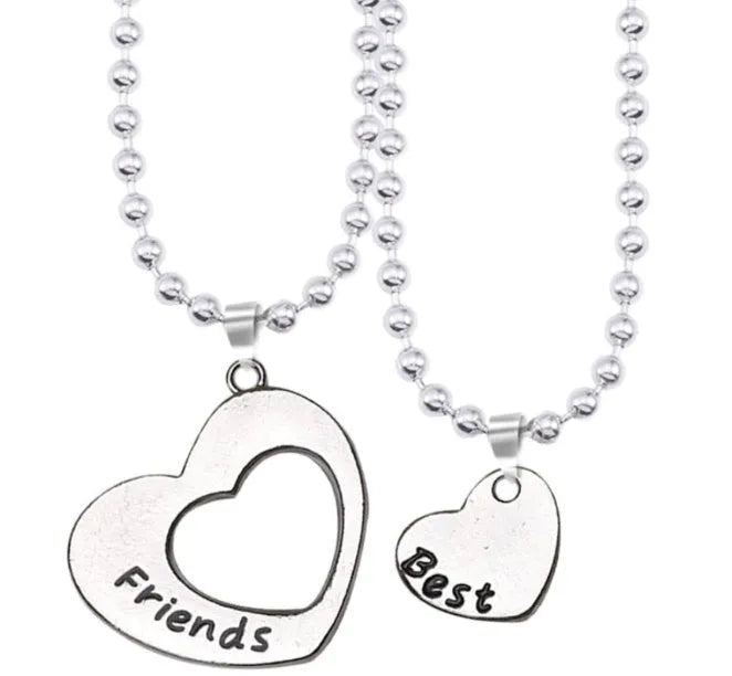Two matching silver heart-shaped cross chain necklaces on a surface, alloy construction
