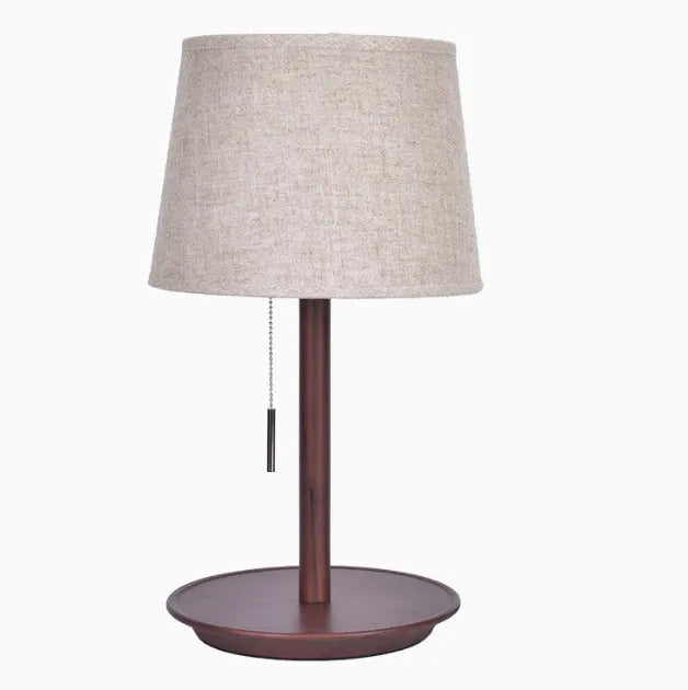 Walnut-coloured solid wood desk lamp with a white fabric lampshade and a black cord switch