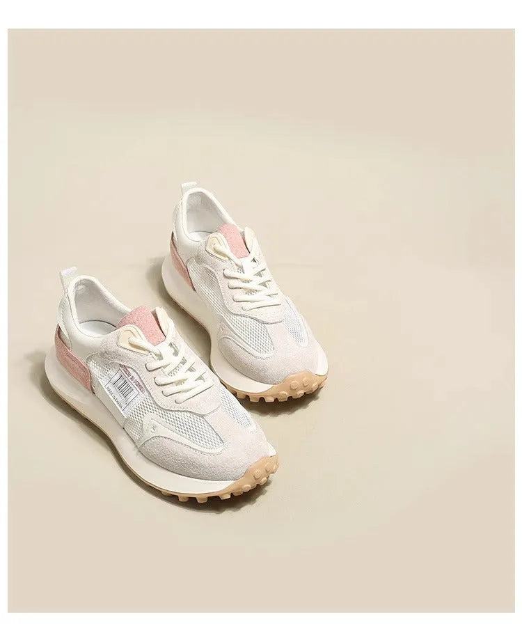 Women's low-top retro sneaker in grey or pink with round toe and rubber sole.